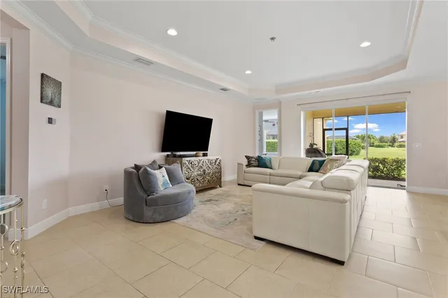 a living room with furniture kitchen view and a flat screen tv