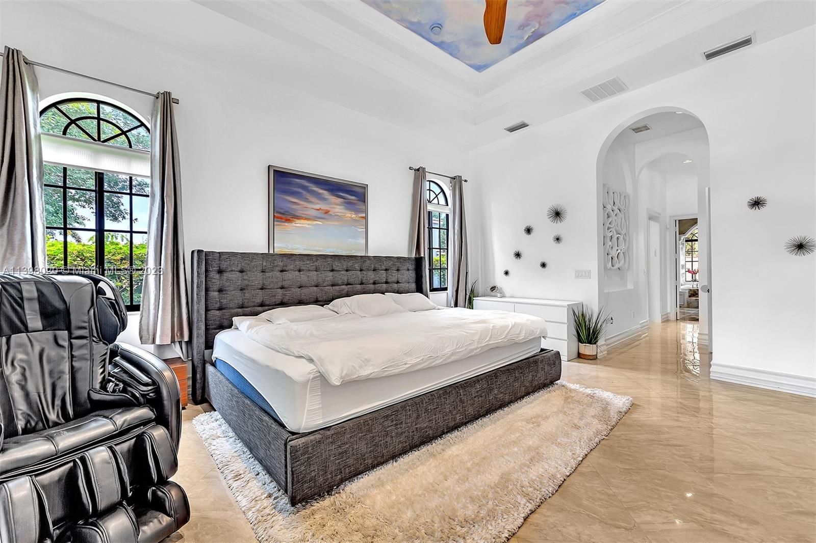 731 Ranch Road Weston, FL 33326 - Photo 17 of 53 a spacious bedroom with a bed a couch and a window