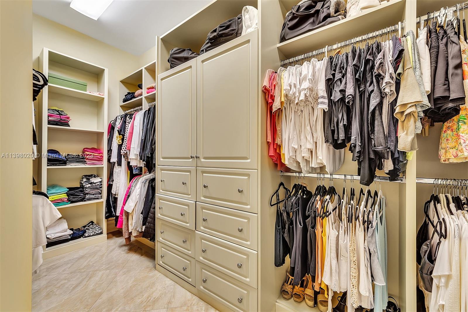 731 Ranch Road Weston, FL 33326 - Photo 21 of 53 a view of walk in closet with clothes and shoes