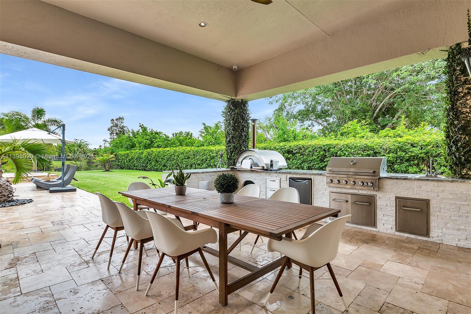 731 Ranch Road Weston, FL 33326 - Photo 24 of 53 a outdoor dining space with furniture and yard