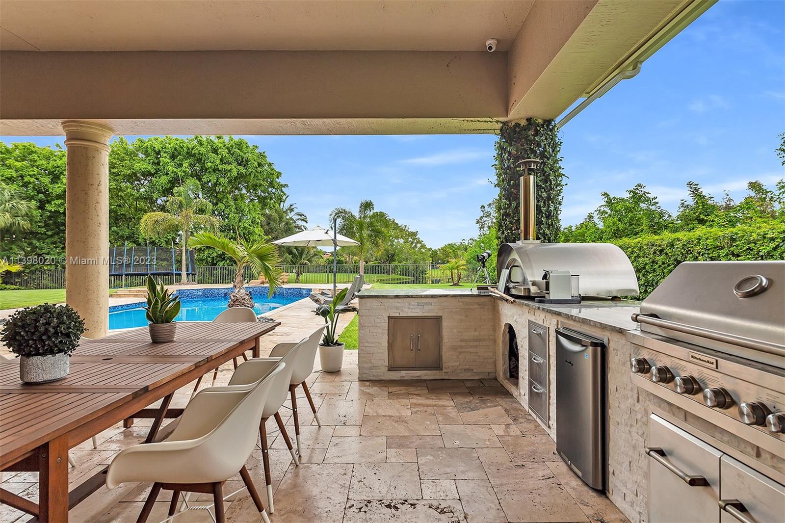 731 Ranch Road Weston, FL 33326 - Photo 25 of 53 a view of a patio with table and chairs and potted plants