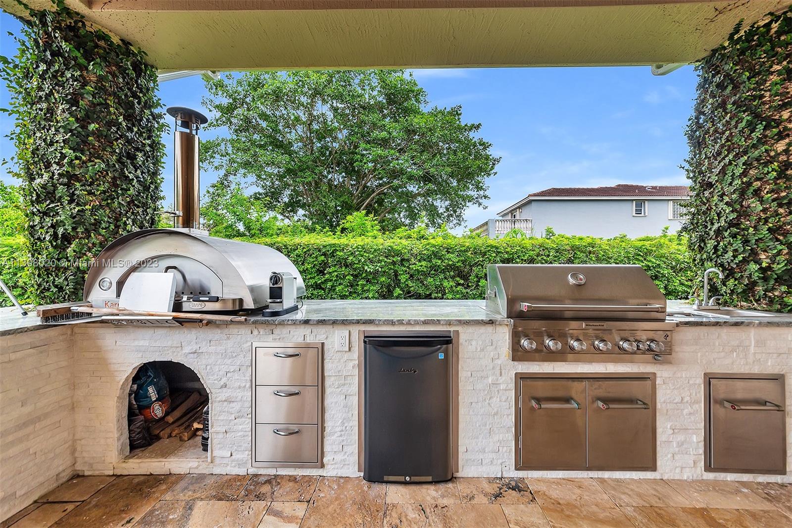 731 Ranch Road Weston, FL 33326 - Photo 26 of 53 a view of a kitchen with a sink and a stove