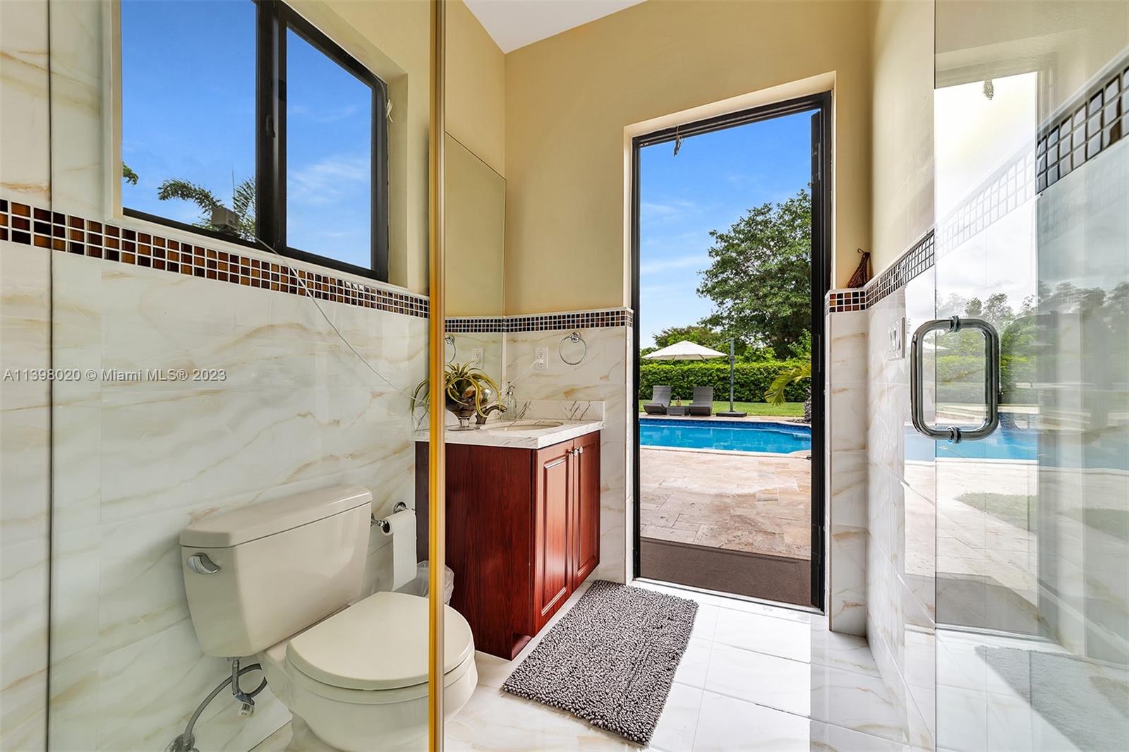 731 Ranch Road Weston, FL 33326 - Photo 32 of 53 a bathroom with a toilet a sink and a shower