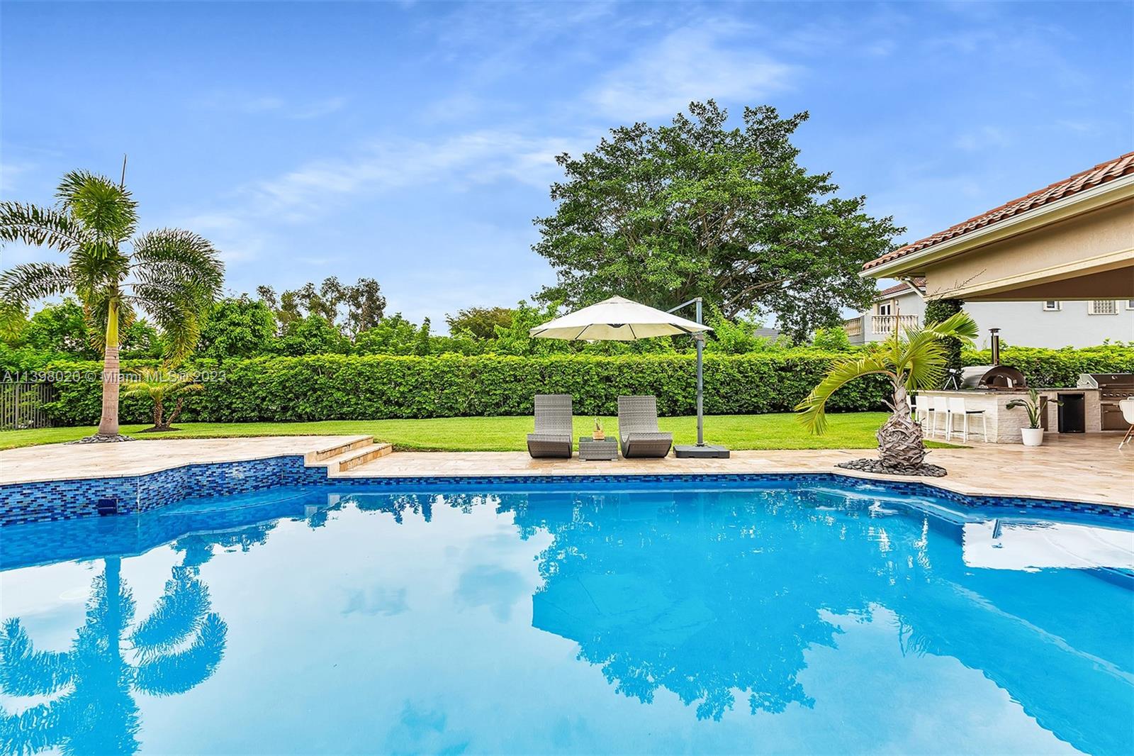 731 Ranch Road Weston, FL 33326 - Photo 34 of 53 a view of swimming pool with lawn chairs and plants