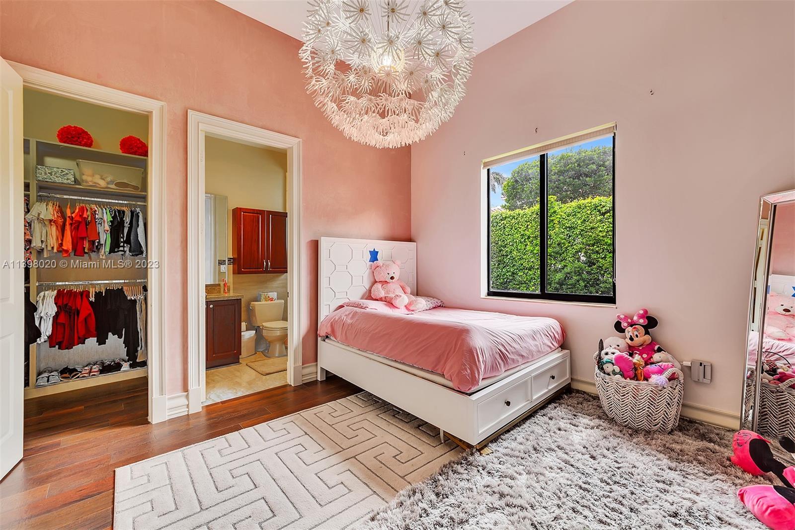 731 Ranch Road Weston, FL 33326 - Photo 35 of 53 a bedroom with bed and a chandelier