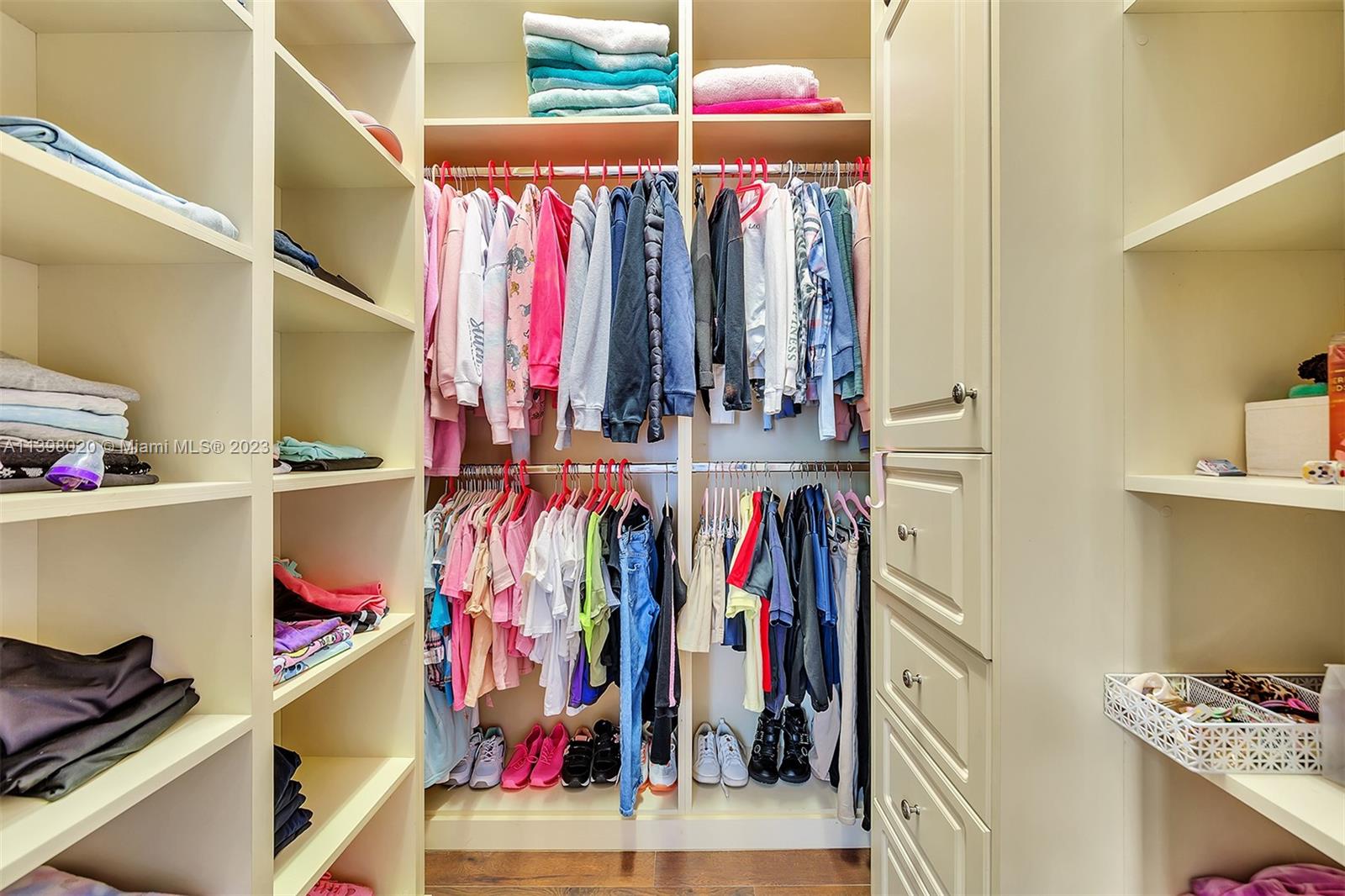 731 Ranch Road Weston, FL 33326 - Photo 40 of 53 a view of walk in closet with clothes