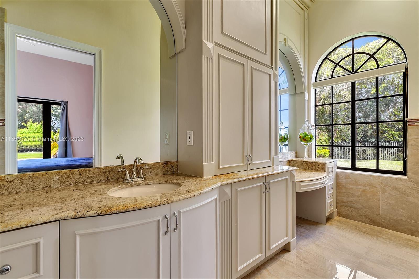 731 Ranch Road Weston, FL 33326 - Photo 44 of 53 a bathroom with a granite countertop a sink and a large mirror