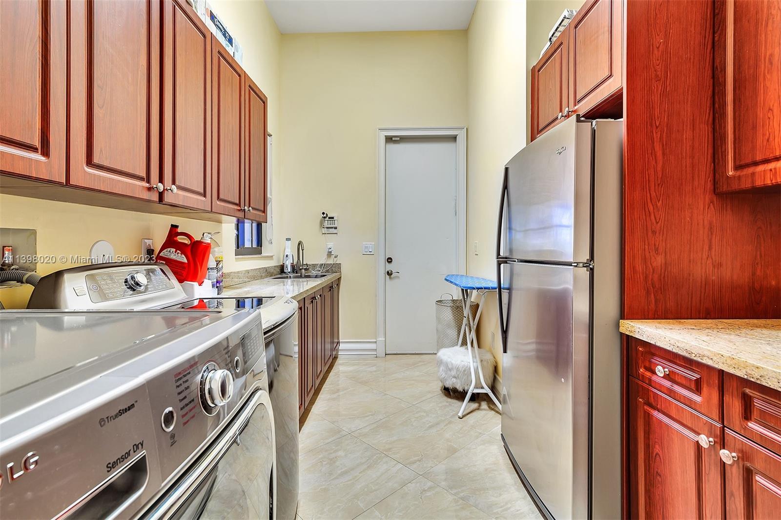 731 Ranch Road Weston, FL 33326 - Photo 46 of 53 a kitchen with stainless steel appliances granite countertop a sink stove and refrigerator