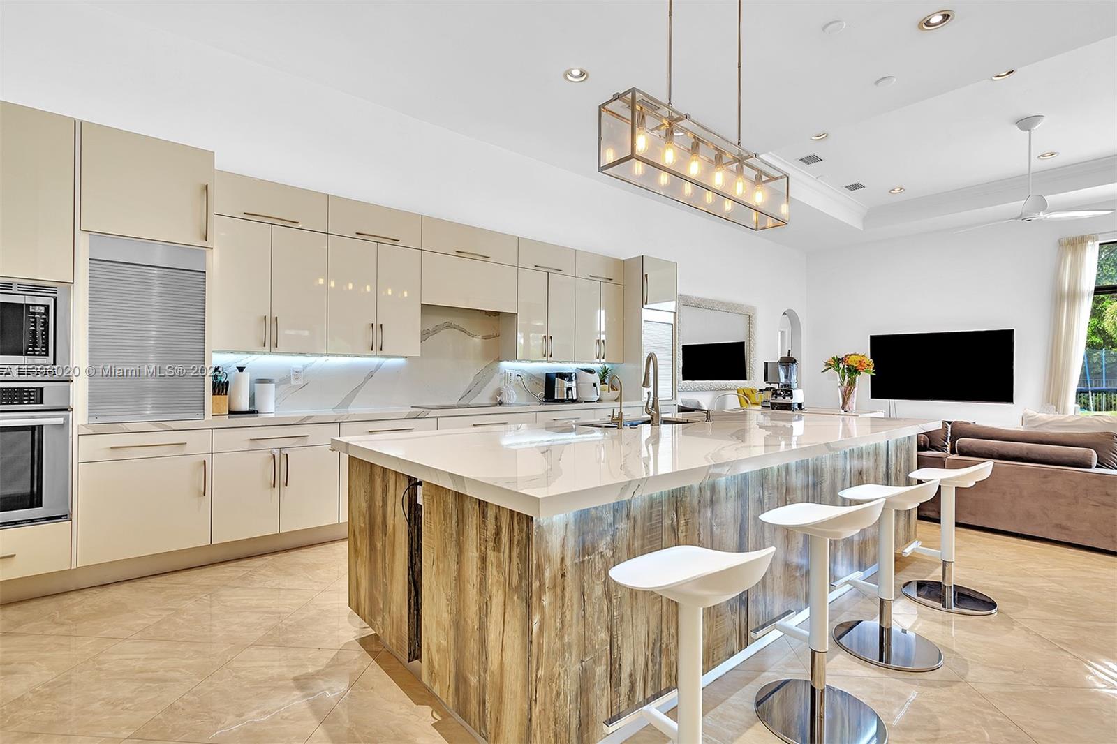 731 Ranch Road Weston, FL 33326 - Photo 6 of 53 a large kitchen with a table and chairs