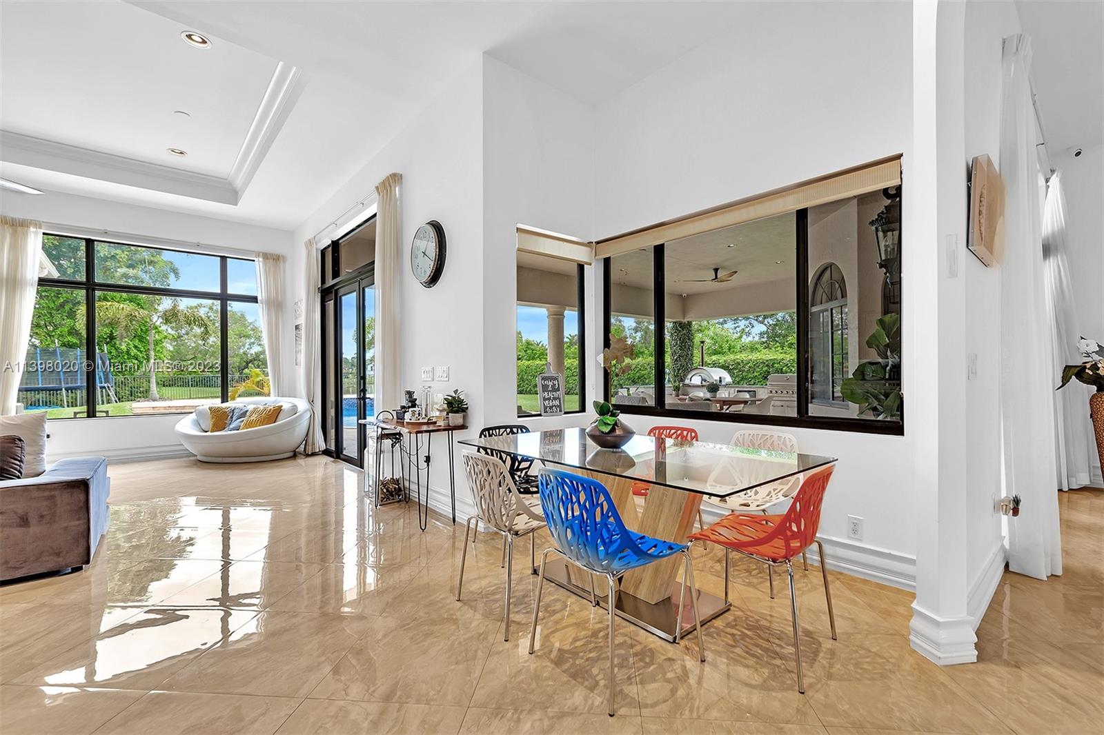 731 Ranch Road Weston, FL 33326 - Photo 10 of 53 a view of a dining room with furniture large windows and wooden floor