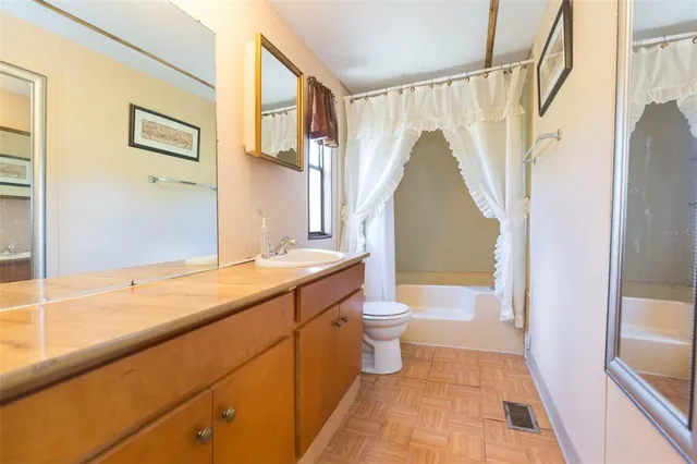 a spacious bedroom with a bed and a couch