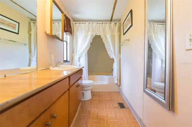 a bedroom with a bed and curtain