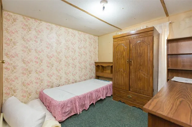 a view of a room with a window and a ceiling fan