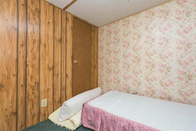 a view of a bedroom with wooden floor