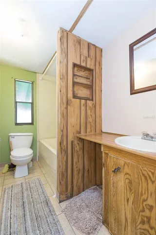 a view of a hallway with furniture and a window