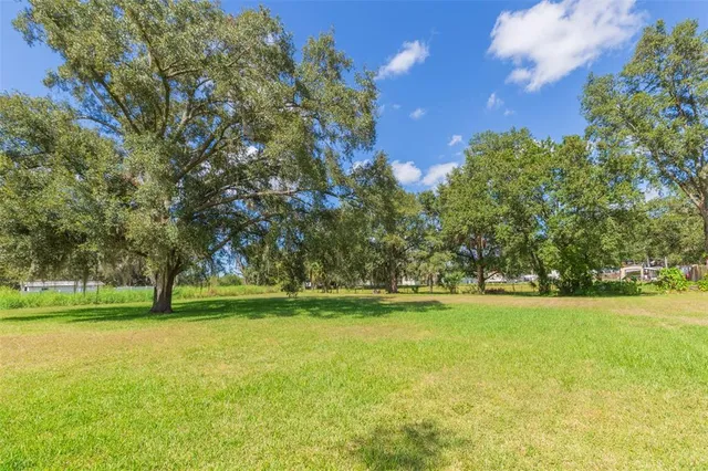 a view of outdoor space with swimming pool and green space