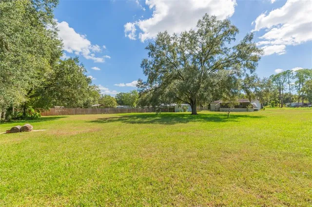 an aerial view of a residential houses with outdoor space and swimming pool