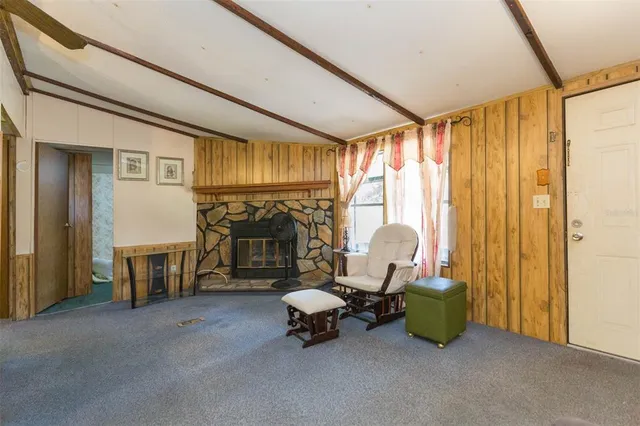 a living room with furniture and a floor to ceiling window