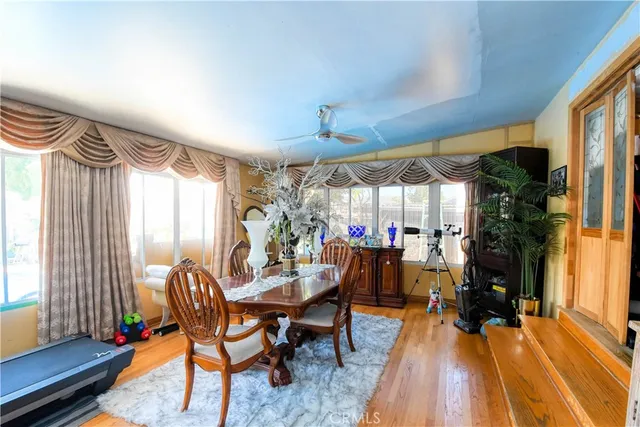 a dining room with furniture and wooden floor