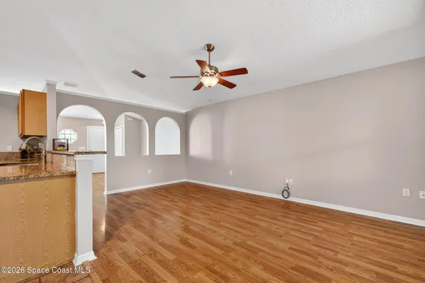 a view of empty room with wooden floor