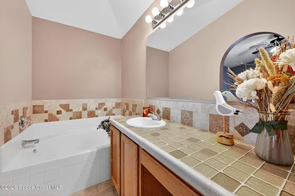a bath room with a sink and a mirror
