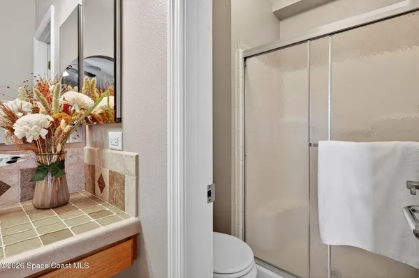 a bathroom with a toilet a sink and shower
