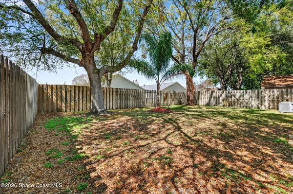 a view of a yard with a house in the background