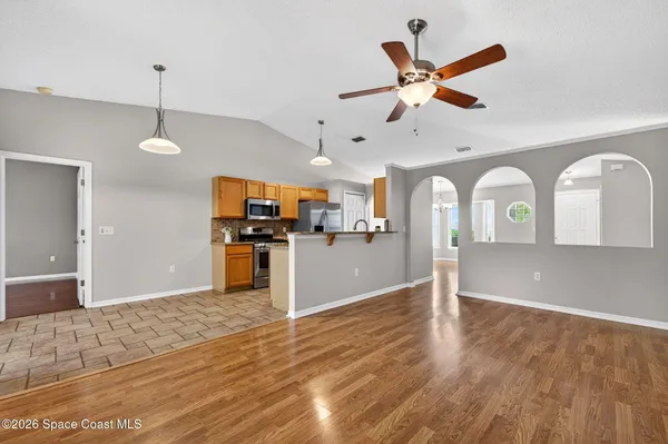 a view of a kitchen with wooden floor
