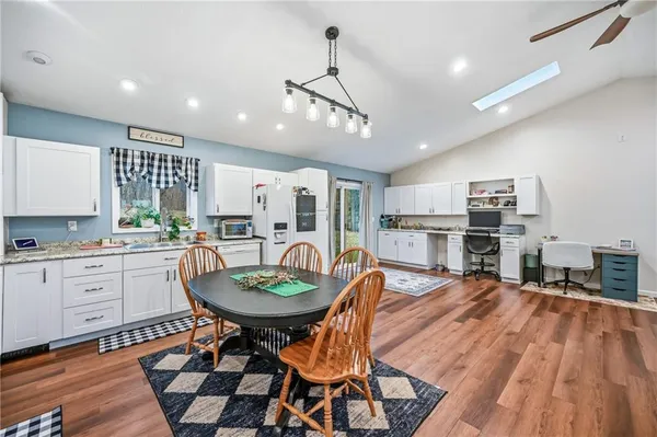 a living room with furniture and kitchen view