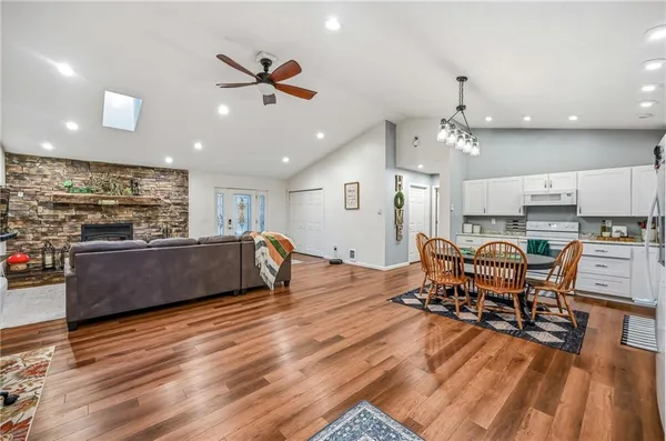 a kitchen with stainless steel appliances granite countertop a refrigerator and a stove top oven