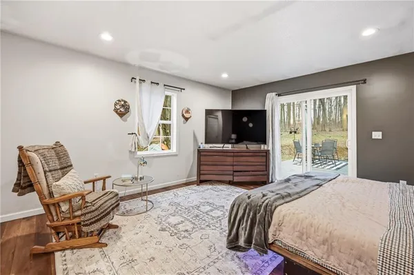 a spacious bedroom with a bed and a lamp