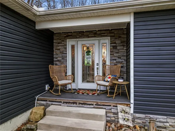 a view of a patio with table and chairs and floor to ceiling window