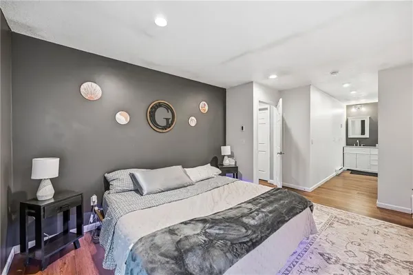 a bathroom with a double vanity sink toilet and a mirror