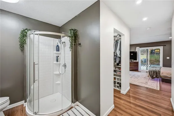 a view of walk in closet with clothes and shoes