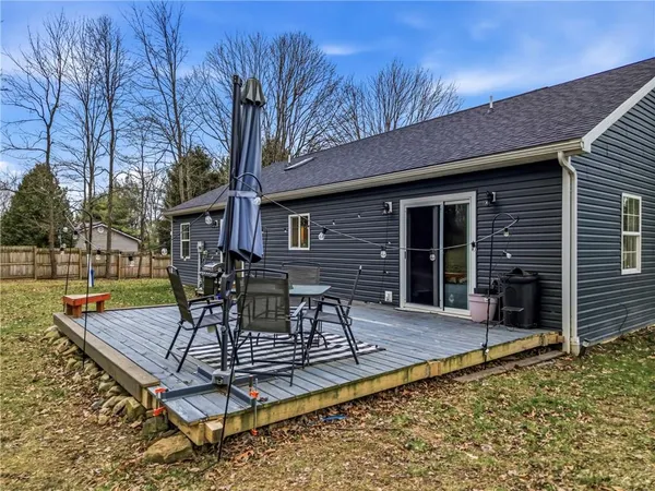 a view of a house with a yard and tree s