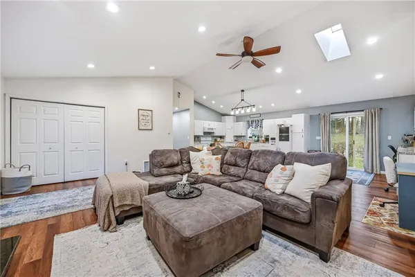 a living room with furniture and wooden floor