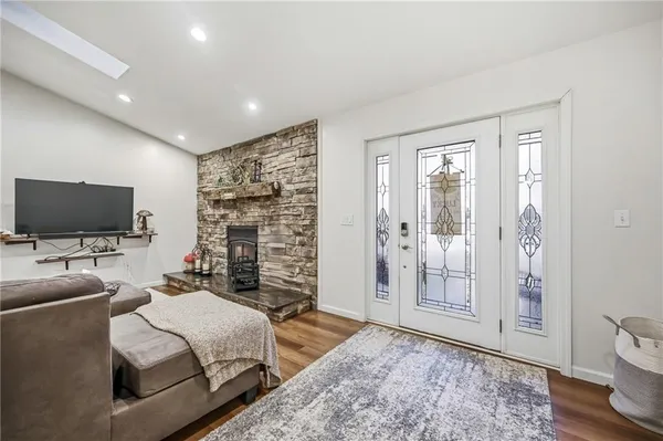 a spacious bedroom with a bed and a flat screen tv