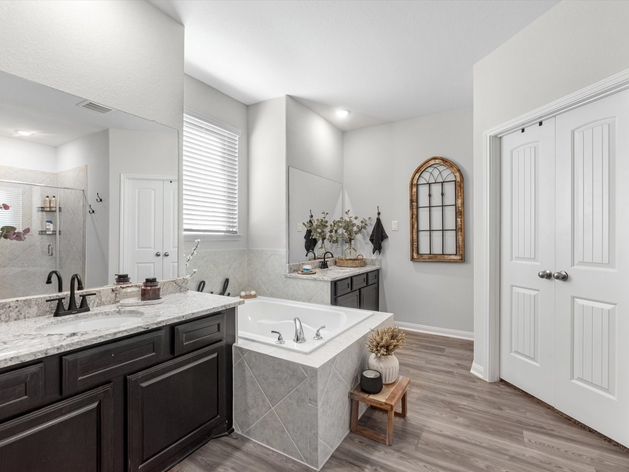 9746 Guadalupe Street Conroe, TX 77303 - Photo 22 of 42 dual vanities, anchored by a large soaking tub. LARGE walk-in closet w/ built-in storage