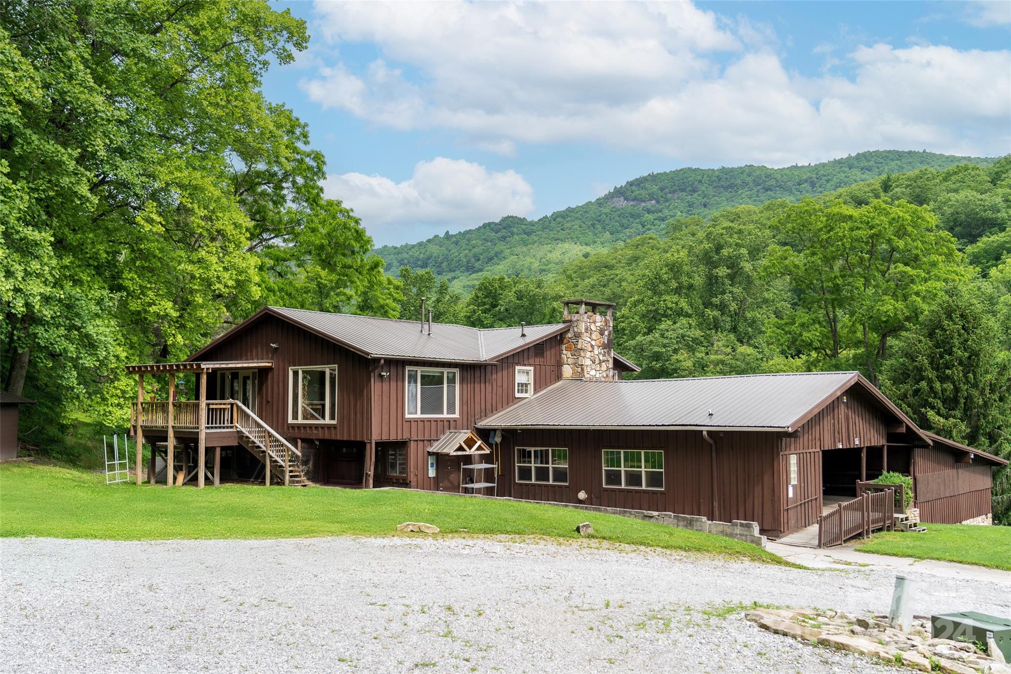 500 Winding Gap Road Lake Toxaway, NC 28747 - Photo 10 of 14 a front view of a house with a garden and trees