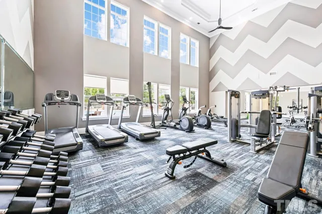 a living room with lots of furniture and a large window