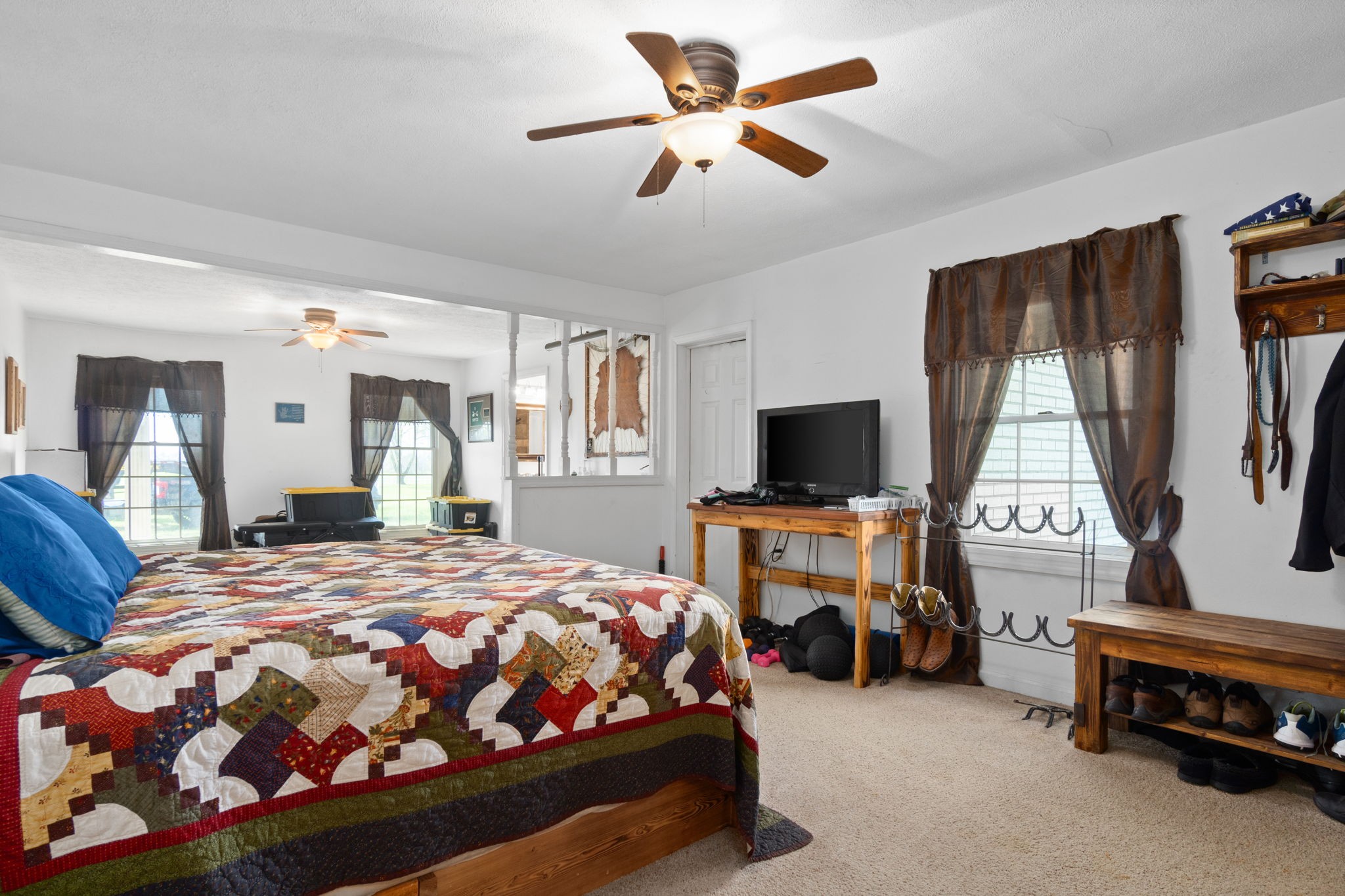 5150 Cadiz Road Hopkinsville, KY 42240 - Photo 23 of 45 a bedroom with a bed and a chandelier
