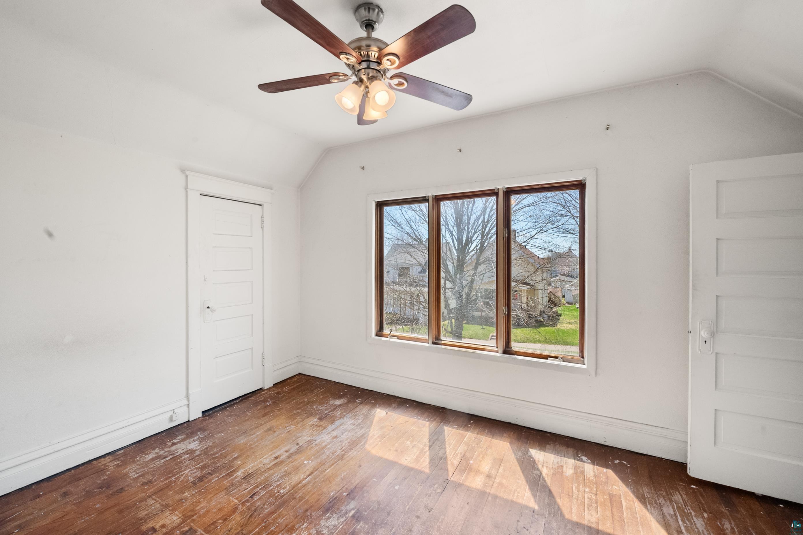 3067 Restormel Street Duluth, MN 55806 - Photo 11 of 25 Room featuring wood-finish flooring, white walls, and a ceiling fan with integrated lighting