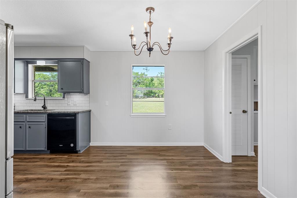 2988 East Old Axtell Road Axtell, TX 76624 - Photo 11 of 38 a view of an empty room with window and wooden floor