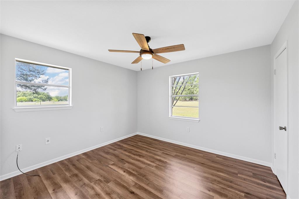 2988 East Old Axtell Road Axtell, TX 76624 - Photo 18 of 38 a view of empty room with wooden floor and ceiling fan