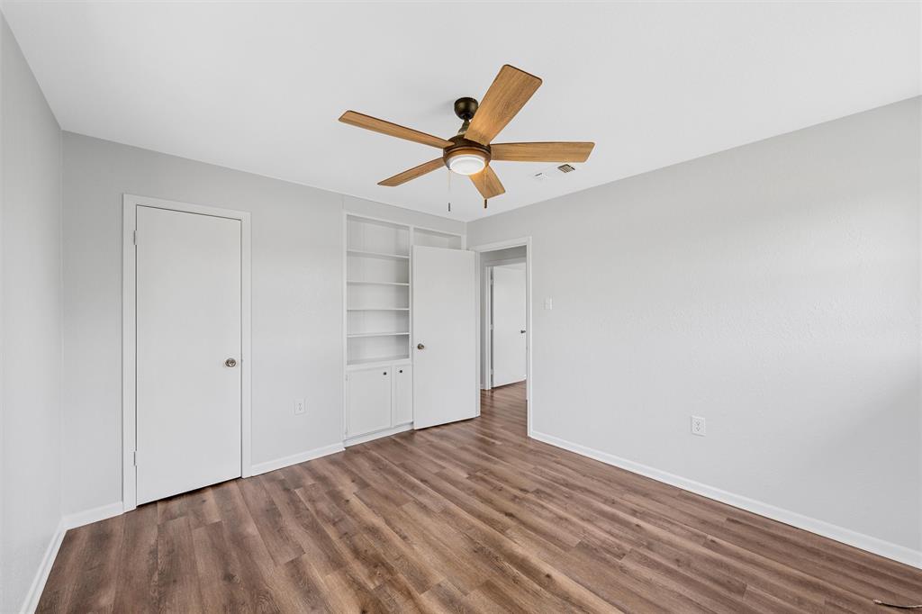 2988 East Old Axtell Road Axtell, TX 76624 - Photo 20 of 38 a view of a room with wooden floor and a ceiling fan