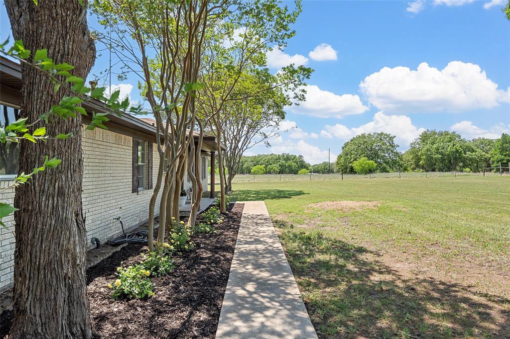 2988 East Old Axtell Road Axtell, TX 76624 - Photo 32 of 38 a front view of a house with garden