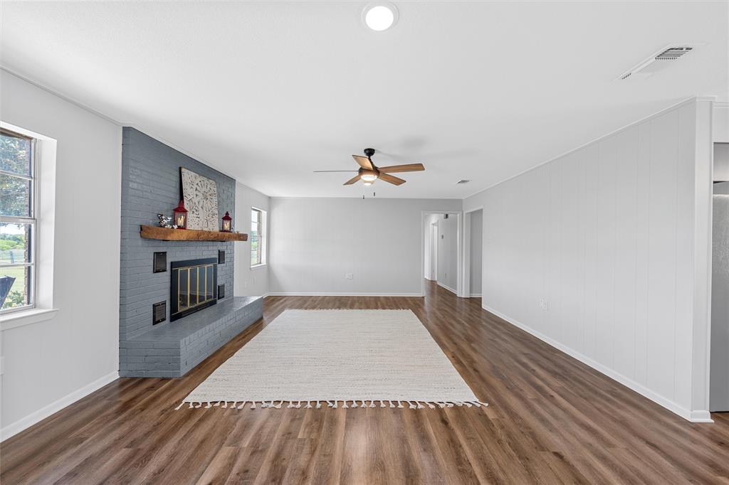 2988 East Old Axtell Road Axtell, TX 76624 - Photo 8 of 38 wooden floor in an empty room with a window