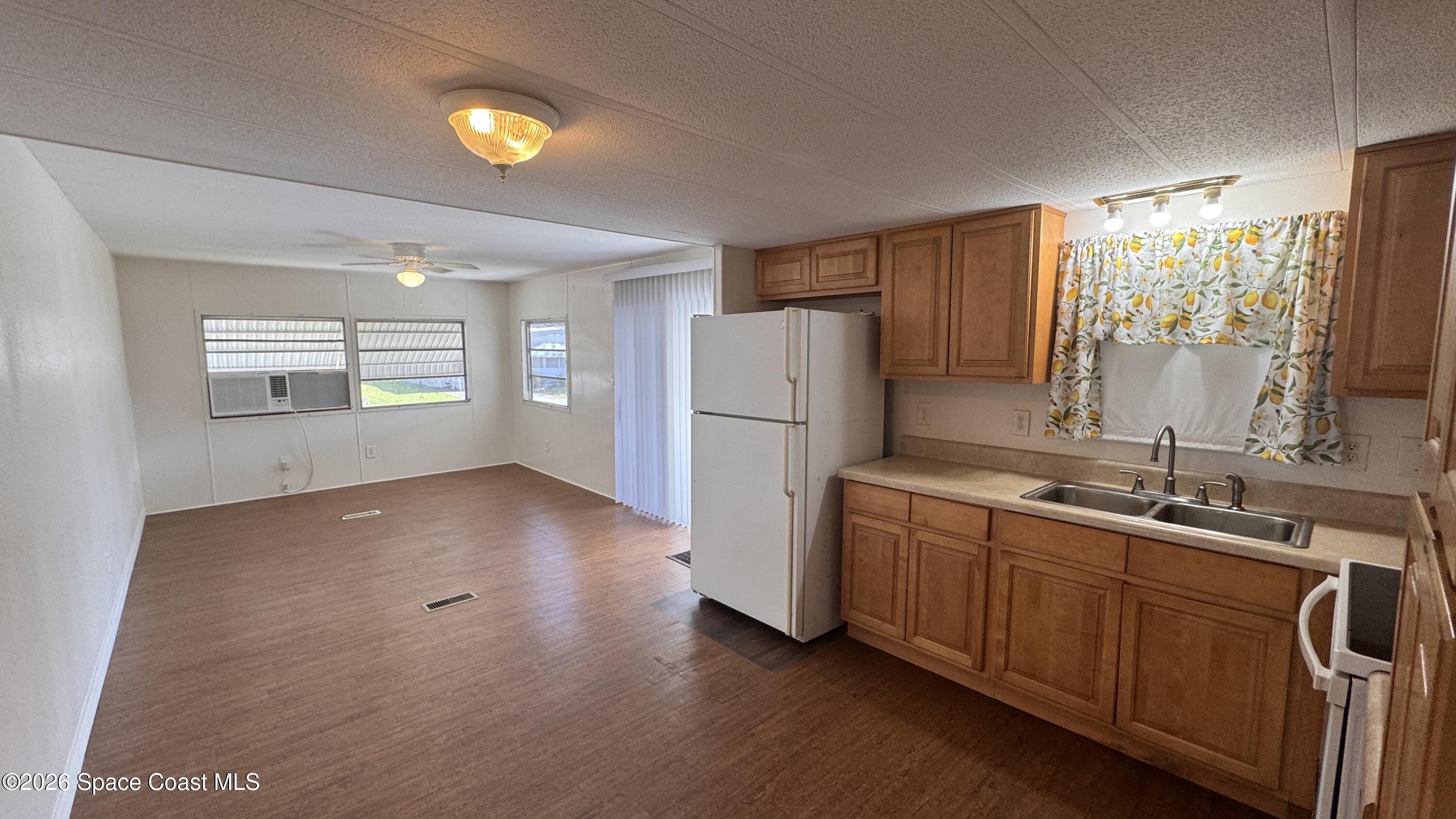2522 Amberly Road Northeast Palm Bay, FL 32905 - Photo 4 of 13 a kitchen with refrigerator and window