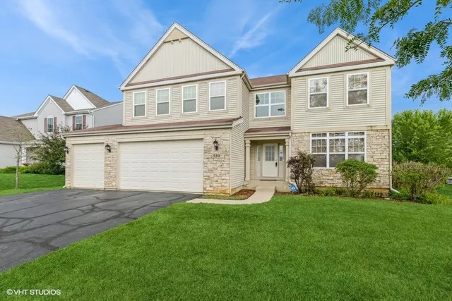 a front view of a house with a yard and garage