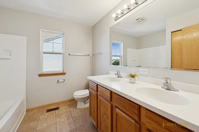 a bathroom with a sink toilet and mirror